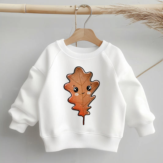 „Kinder-Sweater mit mittig platziertem braunen Eichenblatt-Bügelbild; zeigt Motivgröße und Position klar auf dem Kleidungsstück.“