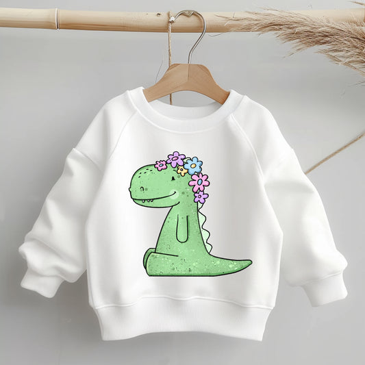 Kinder-Sweatshirt mit mittig platziertem Bügelbild „Rexeline“ (grüner Dino mit pastellfarbenem Blumenkranz), ungefähr handtellergroß.