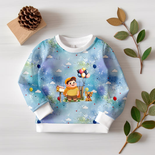 Nahaufnahme des Kinderstoffs „Fliegende Träume“ mit verträumtem Jungen und Hund.