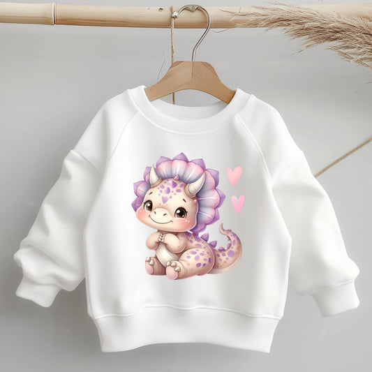Niedliches Dino-Bügelbild in Pastellfarben auf weißem Kinderpullover – ideal für DIY Kleidung.