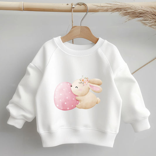 Bügelbild "Hase mit rosa Osterei" auf weißem Kinderpullover – perfektes Oster-Motiv.