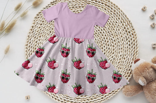 Kinderkleid mit lavendelfarbenem Bio-Jersey-Oberteil und Himbeer-Rock mit Brillen-Motiven.
