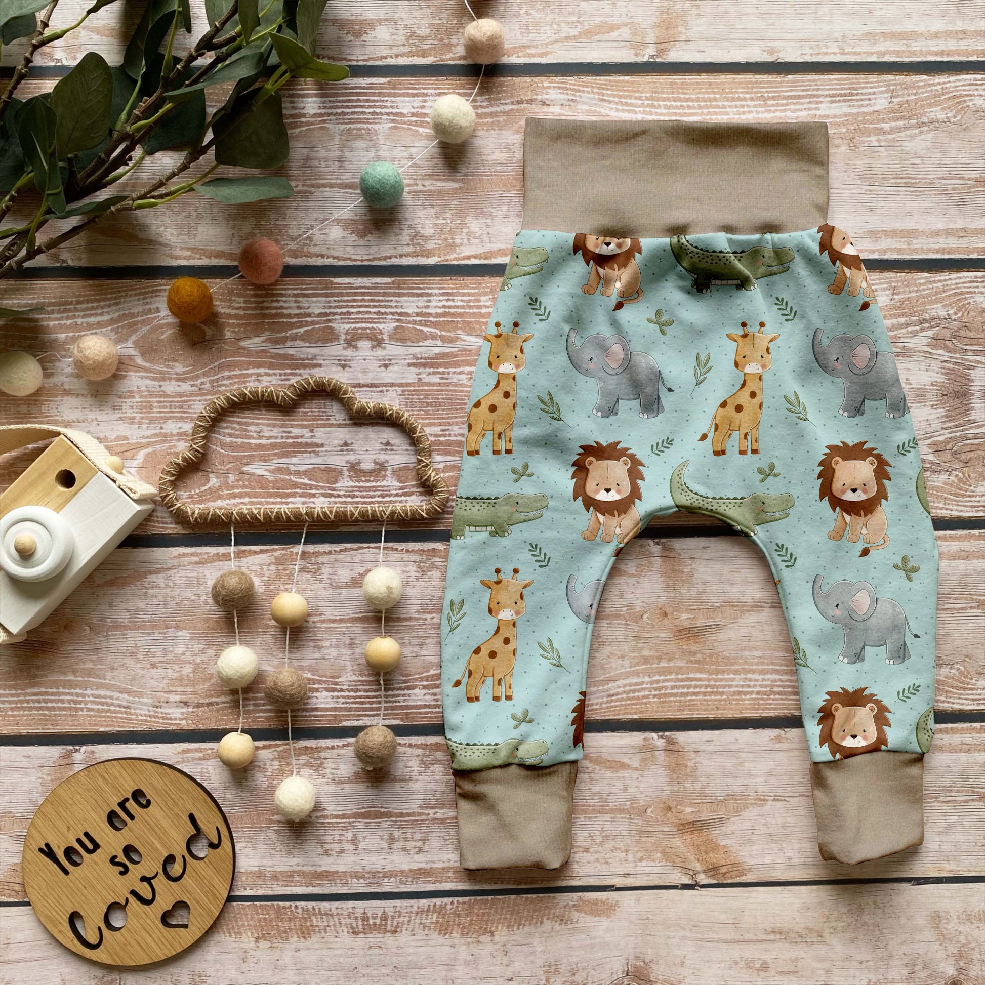 Handgemachte Baby-Pumphose „Babysafari“ mit Bündchen in Beige – weich, bequem & perfekt für kleine Tierfreunde.