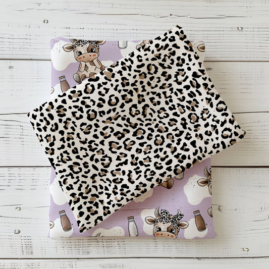 Mockup eines gefalteten Stoffes mit dem Leo-Design: Leopardenmuster in Schwarz und Beige auf hellem Grund – anschauliche Darstellung des Kombistoffs, ideal kombinierbar mit der Schokokuh von Katzengold.