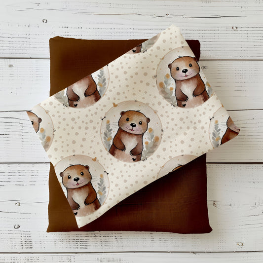 Kinderstoff mit niedlichem Otter in Kreisrahmen auf beigem Hintergrund mit Punkten