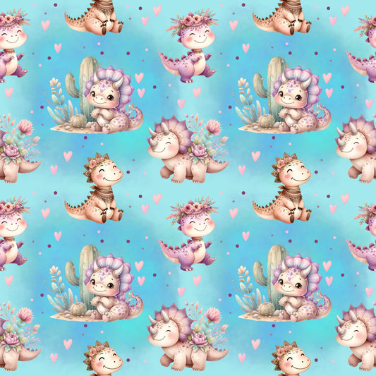 Stoffkachel des Designs „Süße Dinos“ mit fröhlichen Dinosauriern, Herzchen und floralen Details auf mintblauem Hintergrund.